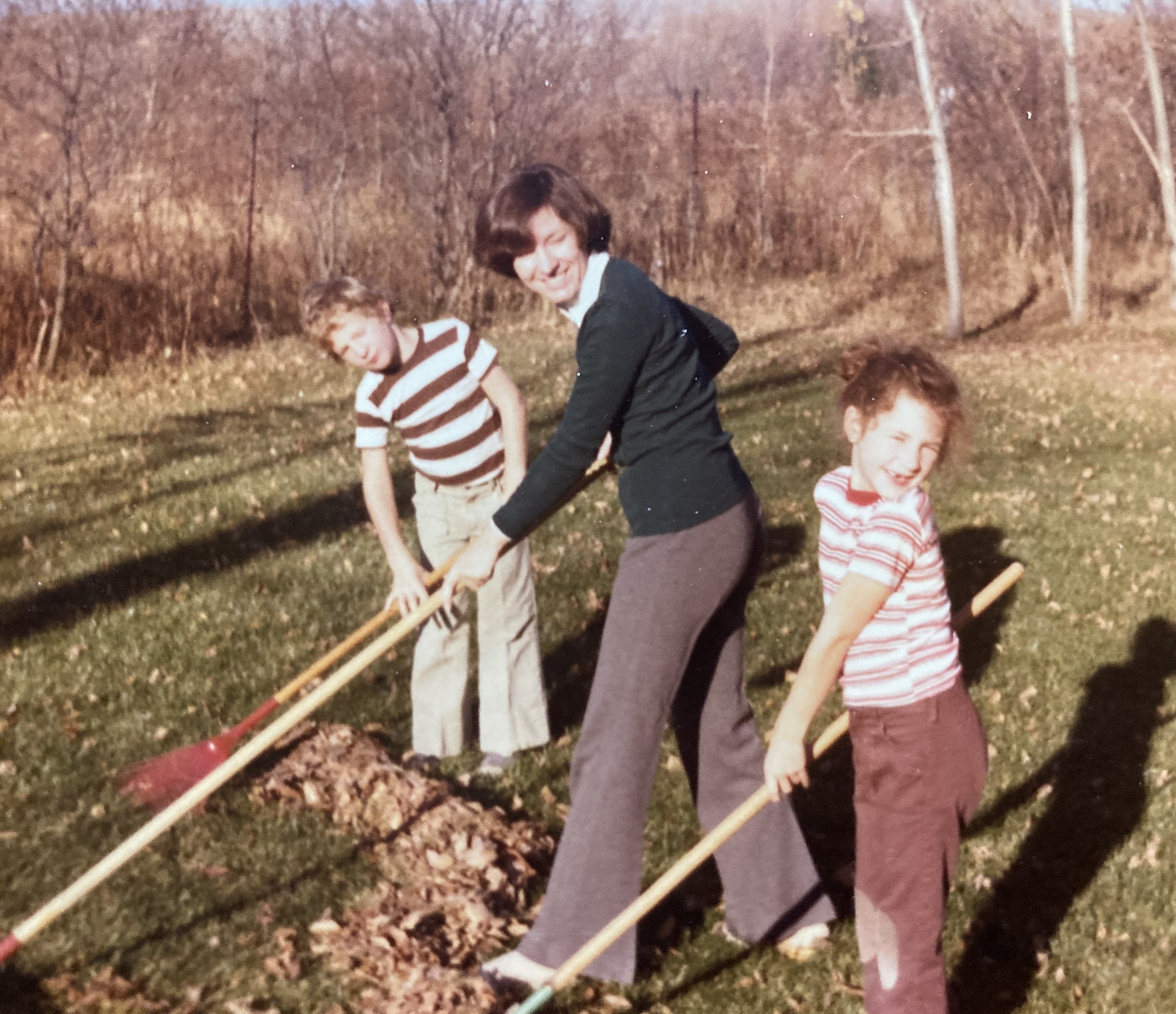 Sean, June and Caia raking leaves in the backyard, 1975-ish